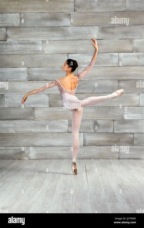 Full Body Back View Of Flexible Female Ballet Dancer Doing Attitude
