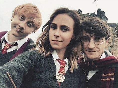 Three People In Harry Potter Costumes Posing For A Photo