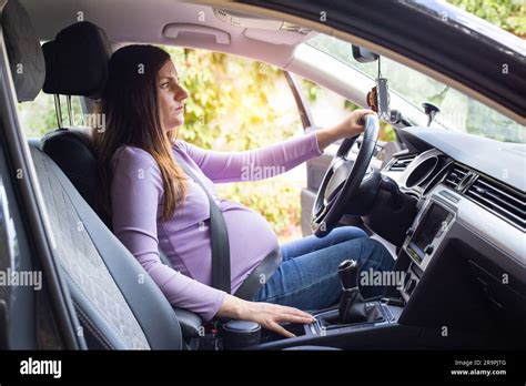 A Pregnant Woman Wearing A Seat Belt Drives A Car Safety And Driving