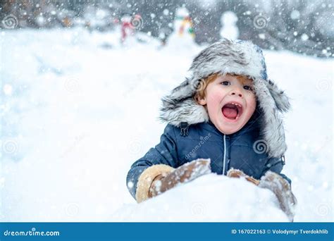 Excited Child Playing With Snow In Park On White Snow Background