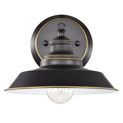 A Black And Gold Light Fixture With An Oval Glass Shade On The Top