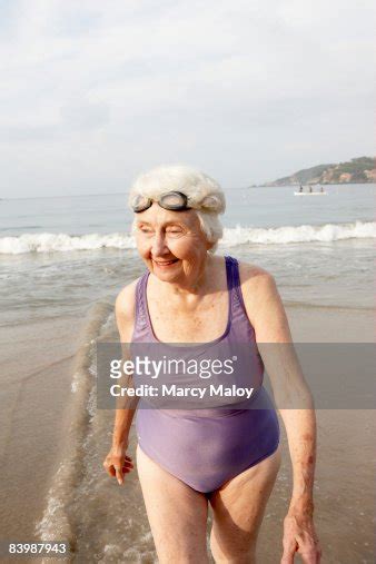 Elderly Woman In Bathing Suit On Beach With Goggle Photo Getty Images