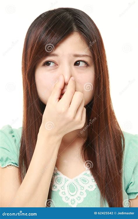 Japanese Woman Holding Her Nose Because Of A Bad Smell Stock Photo