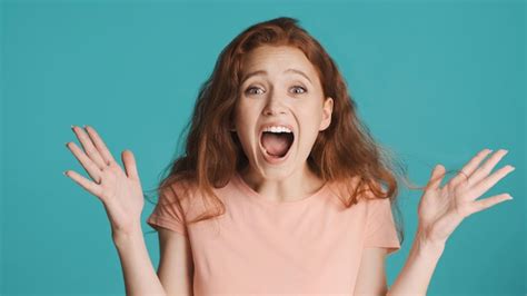 Premium Photo Surprised Emotional Redhead Girl Screaming And Amazedly Looking In Camera Over