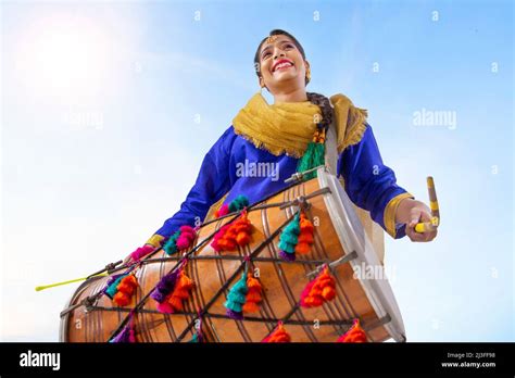 Portrait Of Sikh Woman Playing Drum During Baisakhi Celebration Stock