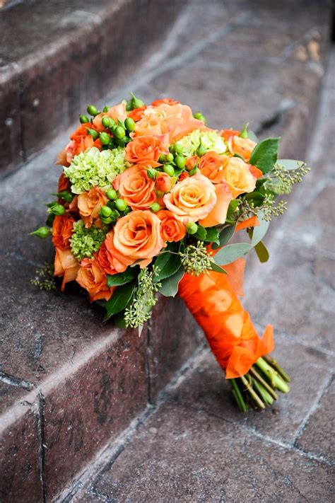 Stick with two or three different colored flowers and mix and match so that they're spread evenly throughout your bouquet. Obsessed with this bouquet- orange roses and green ...