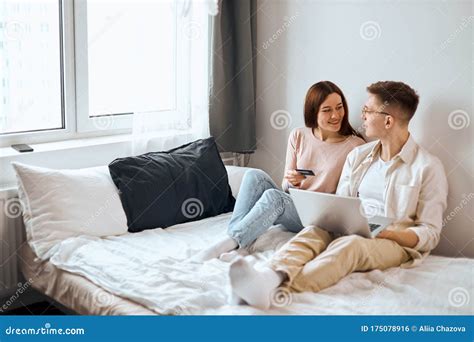 Young Happy People Sitting On The Bed Stock Photo Image Of Attractive