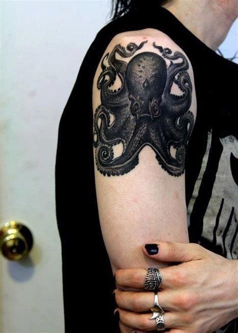 An Octopus Tattoo On The Right Arm And Shoulder Is Shown In Black Ink