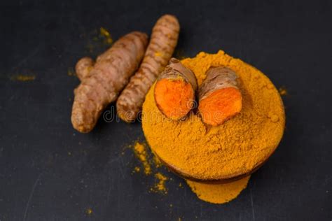 Dried Tumeric Root With Tumeric Powder On White Background Isolated
