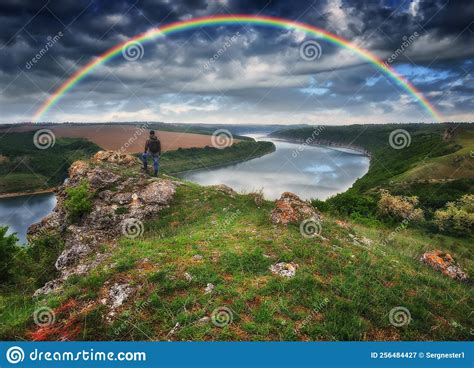 Colorful Rainbow Over The River Man On A Rock Above The Canyon Stock