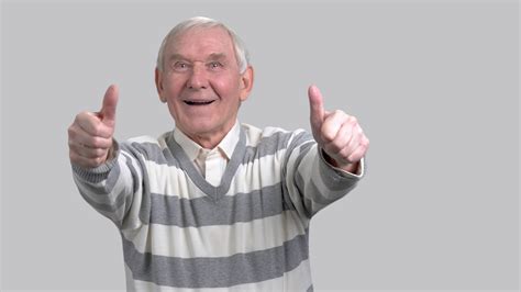 Happy Grandfather With Two Thumbs Up Cheerful Eldery Man Giving Thumbs Up Sign On Grey