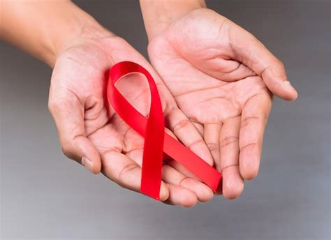Premium Ai Image Photo Of Hands Holding A Red Ribbon Hiv Awareness World Aids Day And World