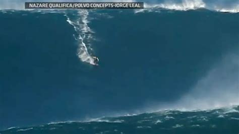 Surfer Garrett Mcnamara Rides Worlds Biggest Wave In Portugal Video