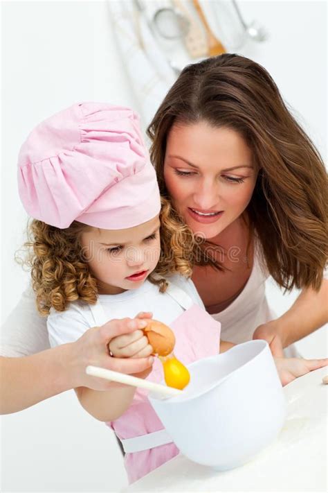 A Mother And Daughter Preparing Food Together In The Kitchen Royalty Photos Stock Images