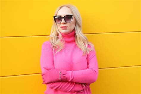 Successful Blonde Woman In Bright Pink Turtleneck And Gloves With