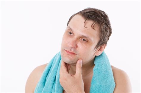 Premium Photo A Man Puts Aftershave On His Face The Guy Strokes His Face Morning Treatments