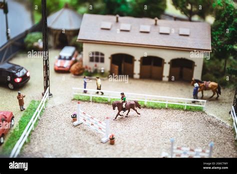Miniature people. Miniature models of horse rider training. Horseback