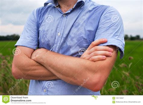 Man With Hyperhidrosis Sweating Very Badly Under Armpit In Blue Shirt