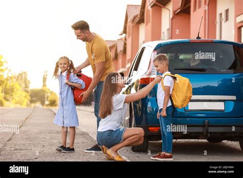 Parents Saying Goodbye To Their Children Near School Stock Photo Alamy
