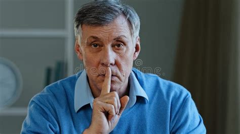 Closeup Old Caucasian 60s Man Holding Index Finger Near Mouth Stop
