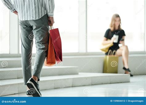 Man Approaching To Girlfriend After Shopping Stock Photo Image Of