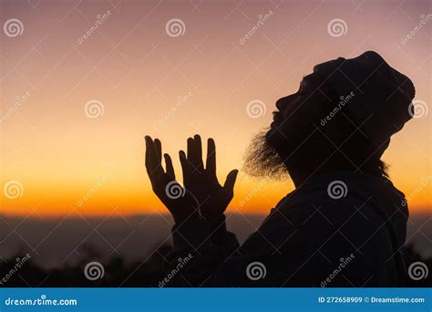 Silhouette Of Man Kneeling Down Praying For Worship God At Sky
