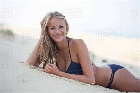 Woman In Bikini Laying On Beach Stock Photo Dissolve