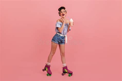 Lovely Pinup Girl Posing On Roller Skates Studio Shot Of Amazed