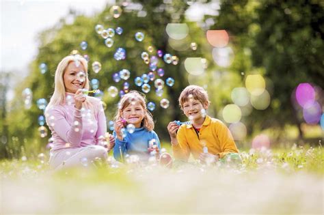Check spelling or type a new query. Mother and children blowing bubbles. - Caravel Autism Health