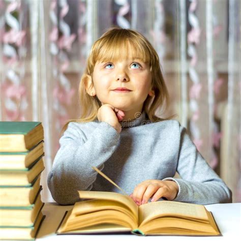 A Girl With A Dreamy Look Looks Up Reading A Book Schoolgirl Is Doing
