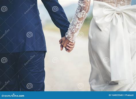 Close Up Of Married Couple Holding Hands In Wedding Stock Photo Image
