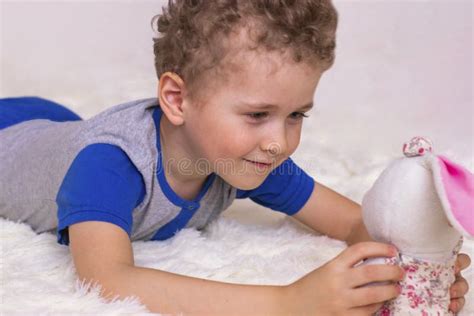 Adorable Kid Boy After Sleeping In His White Bed With Toy Little Happy