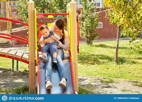 Young Mother With Her Baby On The Playground Stock Photo Image Of