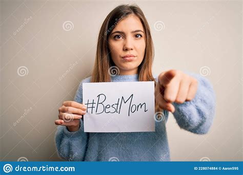 Young Beautiful Woman Holding Paper With Best Mom Message Celebrating Mothers Day Pointing With