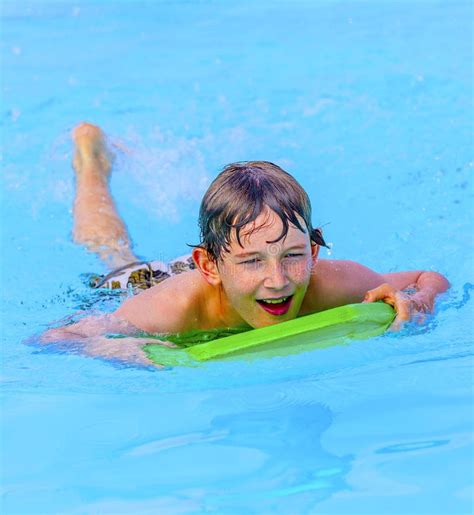 Smiling Teen Boy Swimming In Pool Stock Photo Image Of Cheerful