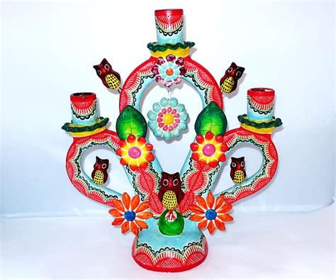 A Colorful Vase With Owls And Flowers On It