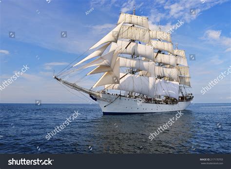 Tall Ship Under Sail With The Shore In The Background