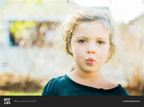 Portrait Of Young Girl Whistling In Yard Stock Photo Offset
