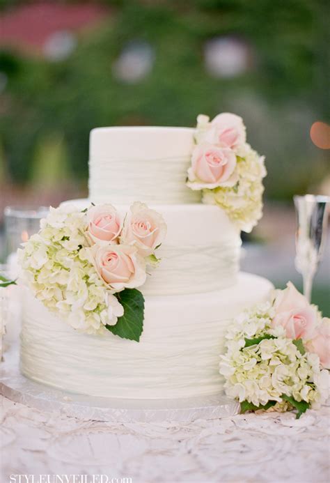 The white roses were all made by hand as was the stenciling on the top and middle tiers by sweet art. All White Wedding Cakes - Belle The Magazine