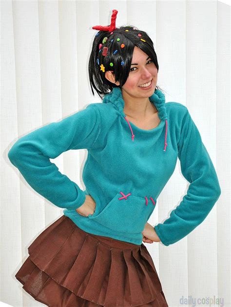 A Woman In A Blue Sweater And Brown Skirt With Her Hands On Her Hips