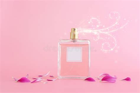 Image Of Elegant Perfume Bottle Spraying Over Pink Pastel Background