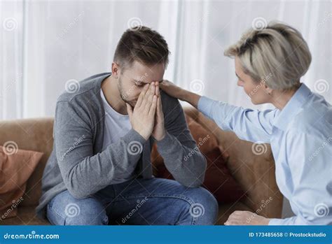 Professional Psychologist Comforting Crying Man During Appointment In