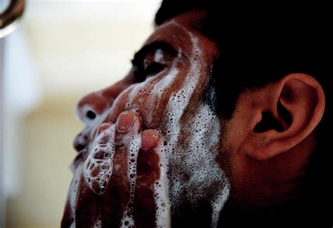 man washing face by tracy rutter science photo library