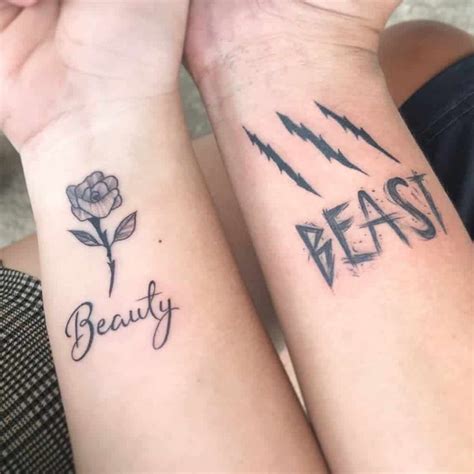 Two People With Matching Tattoos On Their Arms That Say Beauty And