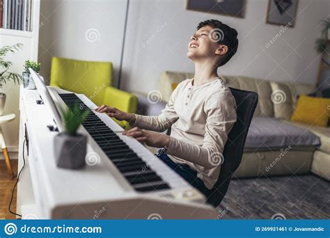 Boy Playing Piano In Living Room Child Having Fun With Learning To