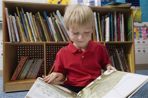 Inspire a love of reading with amazon book box for kids. Little boy reading a picture book Stock Photo - 1906283 ...