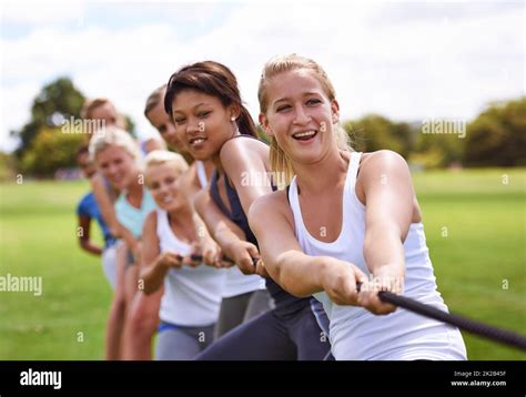 One Two Three Pull Cropped Shot Of A Girls Tug Of War Team Training Outdoors Stock Photo