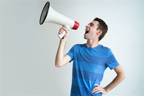 Free Photo Excited Attractive Man Shouting Into Megaphone