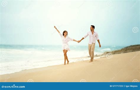 laughing couple in love holding hand on beach stock image image of horizontal romance 57771723