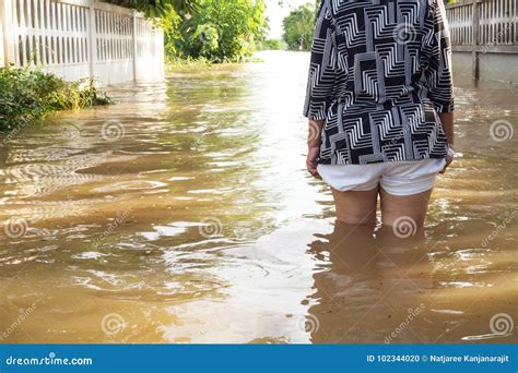 Woman Wade Flooding In Her House Closeup On Her Leg Stock Photo